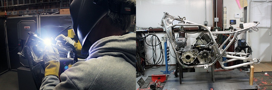 Man welding motorcycle in a shop